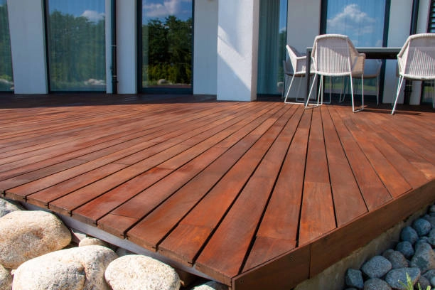 Modern wooden deck with clean lines and outdoor seating area. -deck repair services